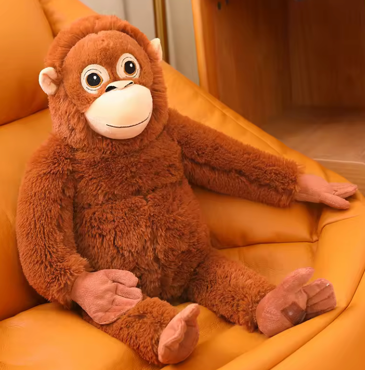 Plush monkey toy sitting on a yellow couch